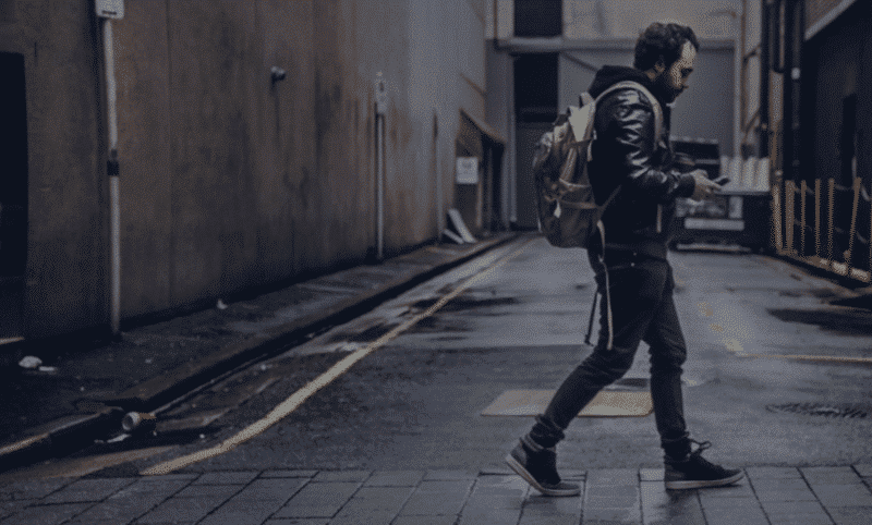 man walking with backpack